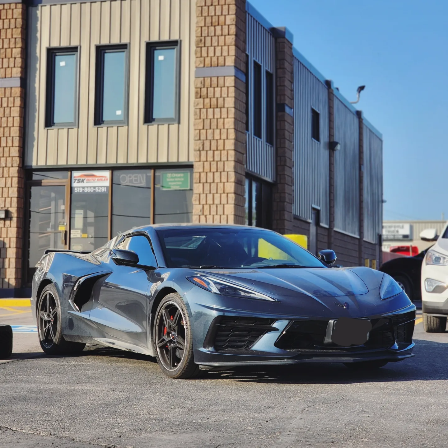 Certified pre-owned vehicle out front of the shop